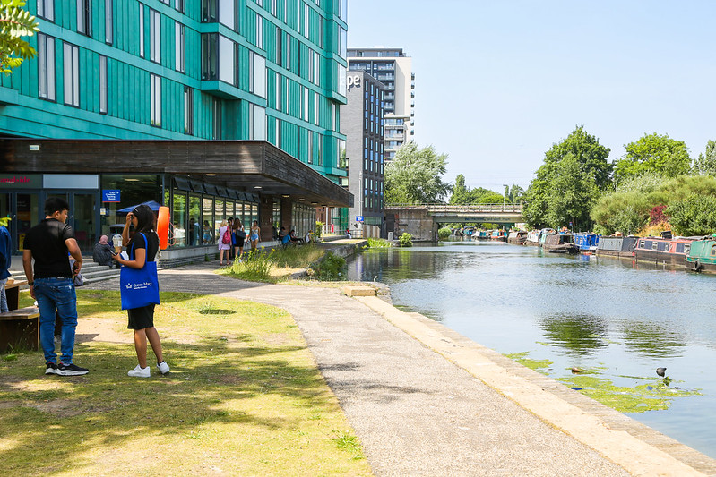 students walking by canal