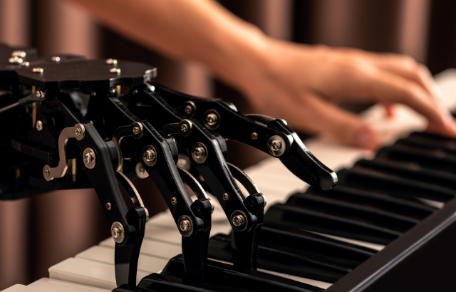 A robotic arm playing a piano.