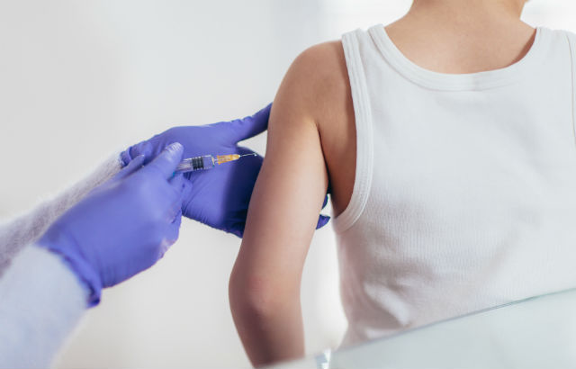 A doctor administering an injection to a patient