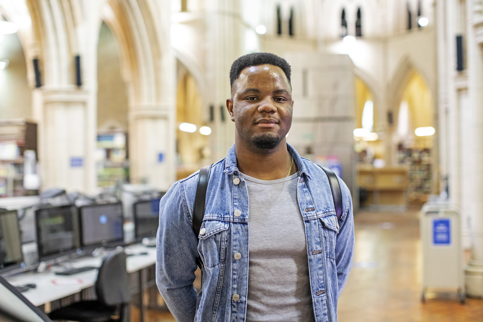 A student standing in the library at Whitechapel