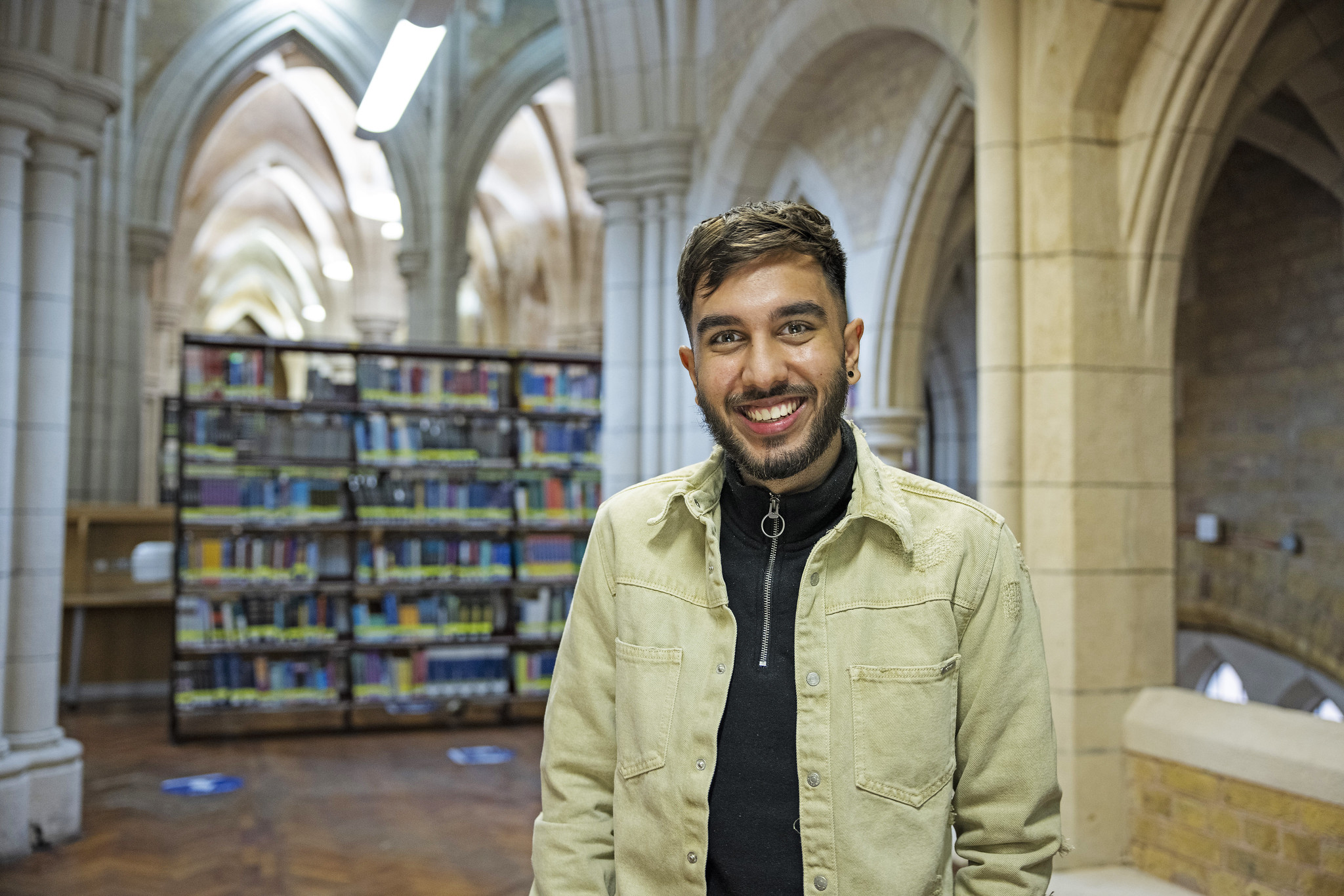 A student standing in the library at Whitechapel