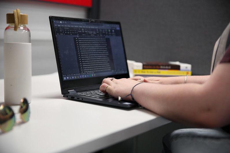 A student types code on a laptop computer