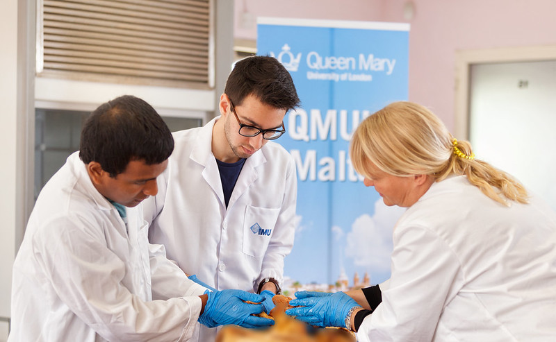 Three students in lab coats