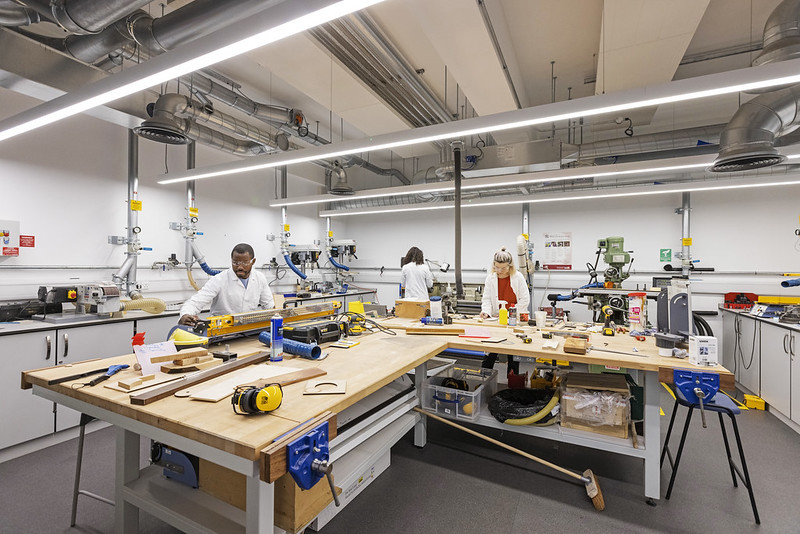 Three students working in an engineering workshop