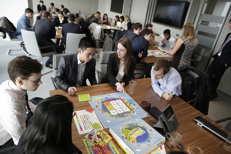 People interacting with activities on different tables