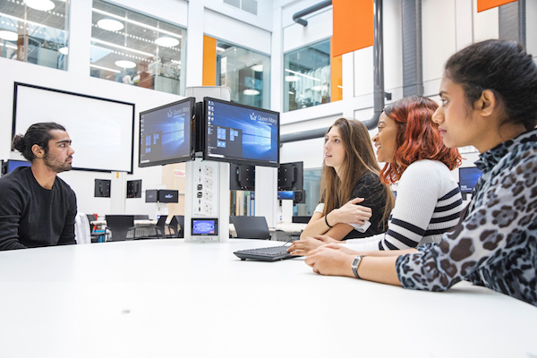 Four engineering students looking at a screen