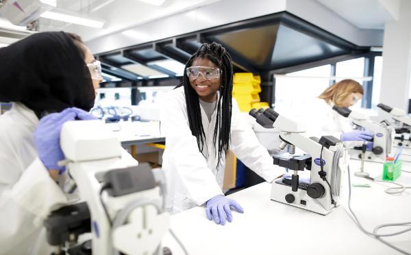 Three female chemistry students working in the lab