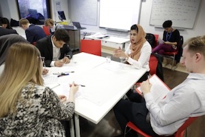 Four people sitting round a table at a workshop