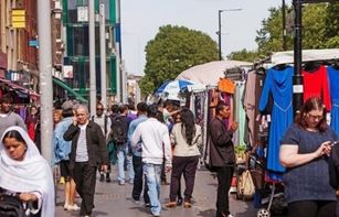 Members of the public walking along Whitechapel street market in east London