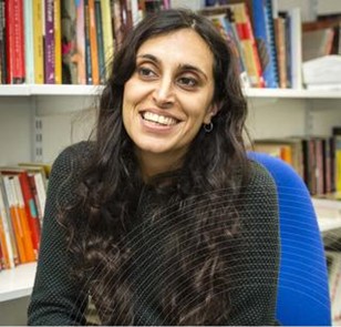 portrait of Shital Pravinchandra in front of bookshelves