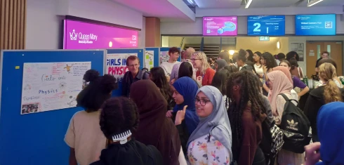 A photo of students and academics networking at the girls into physics summer school 2023.