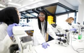 A decorative image of Queen Mary students in a laboratory