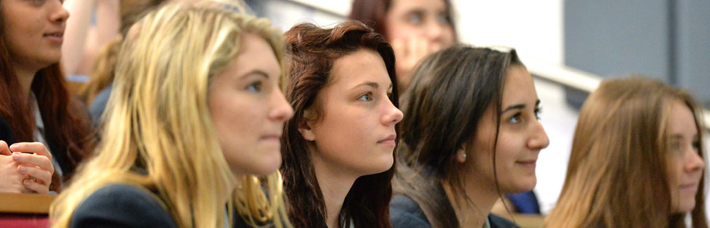 A decorative image showing students in a lecture