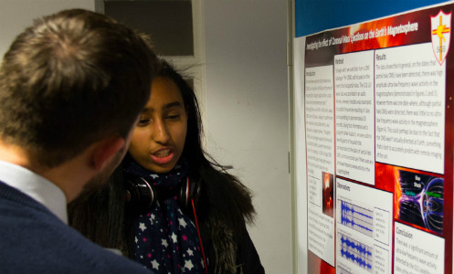 Student presenting a poster at Cosmic Con