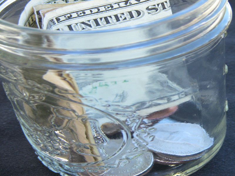 A jar full of notes and coins