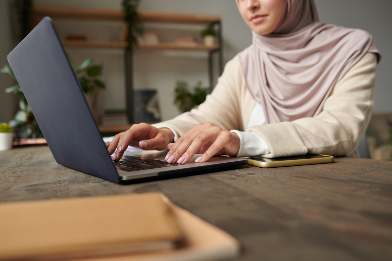 Student typing on a laptop