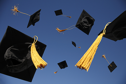 Graduand hats in the air