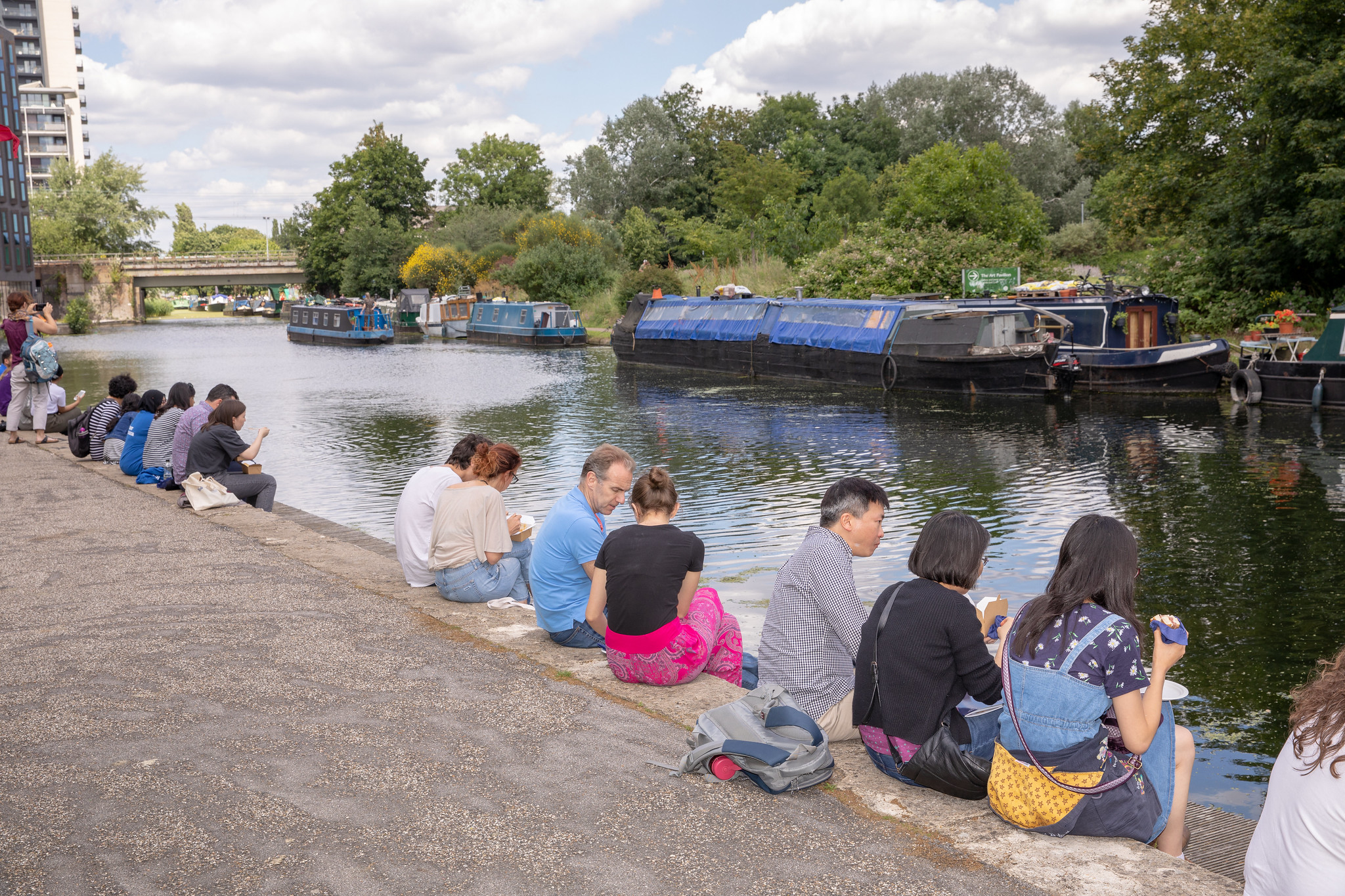 People sitting by the canal