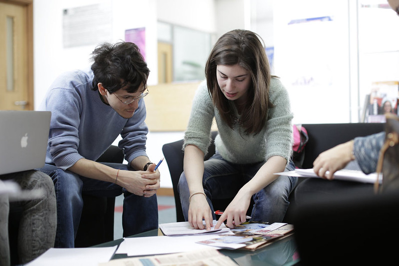 Two people discussing about documents