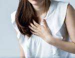 Woman placing hand on her chest