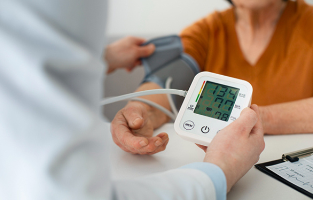 Doctor checking patient's blood pressure