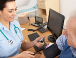 Nurse taking patient's blood pressure.