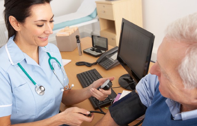 Nurse taking patient's blood pressure.