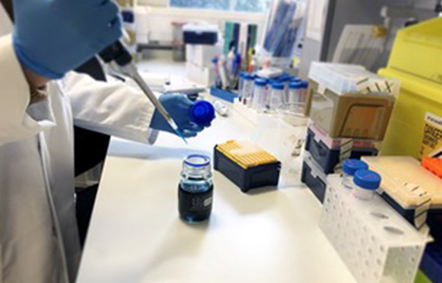 Researcher holding a pipette