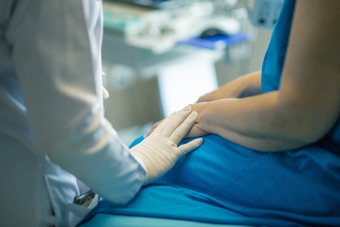 A doctor comforts a patient prior to surgery